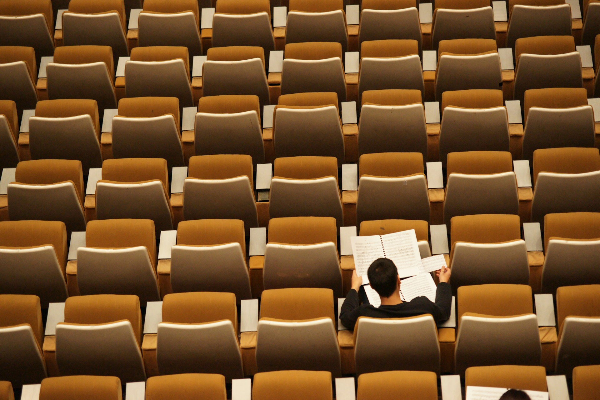 Student studying in empty classroom